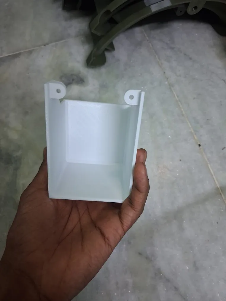 Custom 3D printed enclosure held in hand for scale